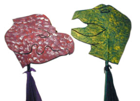 red Protoceratops and green Tyrannosaurus Rex hobbyhorse heads